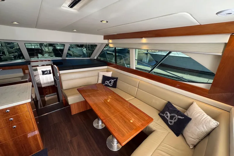  Yacht Photos Pics Luxurious interior of 2016 Riviera 43 Open Flybridge yacht with elegant seating and wooden table.