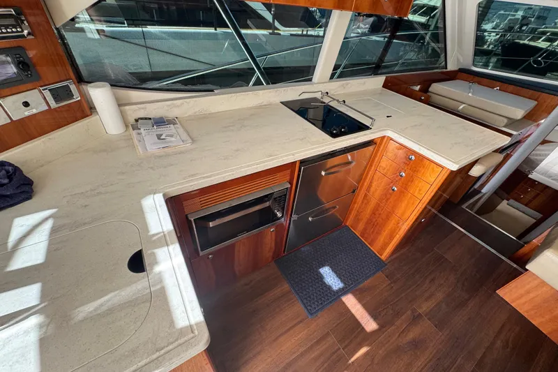  Yacht Photos Pics Luxurious 2016 Riviera 43 Open Flybridge yacht interior with modern kitchen and wood finish.