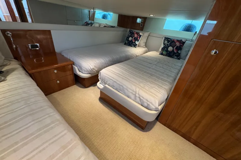  Yacht Photos Pics 2016 Riviera 43 Open Flybridge cabin with twin beds and wooden furnishings.