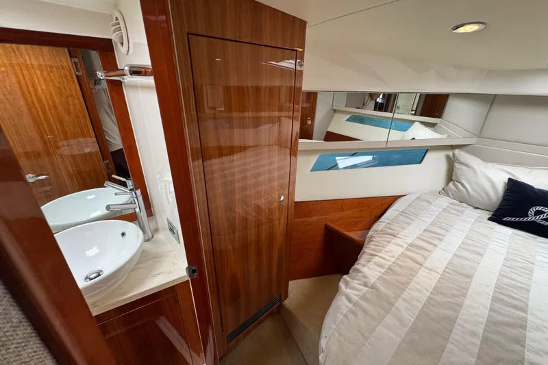  Yacht Photos Pics Luxurious interior of 2016 Riviera 43 Open Flybridge yacht with cozy bedroom and modern bathroom.