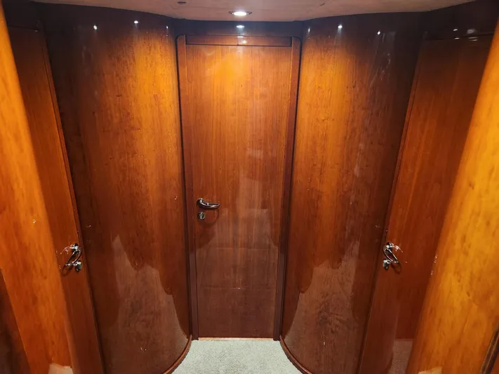 F66 Yacht Photos Pics Interior hallway of 1997 Fairline 66 yacht with polished wooden doors.
