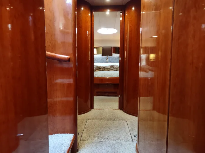 F66 Yacht Photos Pics Interior hallway of 1997 Fairline 66 yacht with polished wood finish.