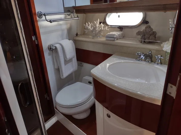 F66 Yacht Photos Pics Luxurious bathroom in a 1997 Fairline 66 yacht with modern fixtures and elegant decor.