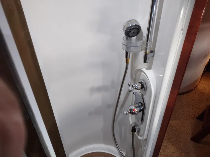 F66 Yacht Photos Pics Shower area in a 1997 Fairline 66 yacht with chrome fixtures.