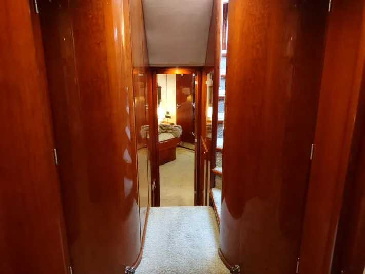 F66 Yacht Photos Pics Hallway inside a 1997 Fairline 66 yacht with polished wood paneling.