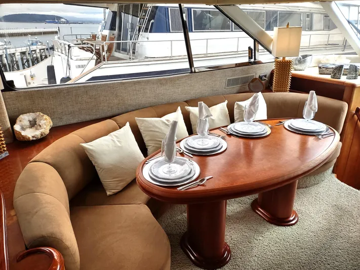 F66 Yacht Photos Pics Luxurious dining area inside a 1997 Fairline 66 yacht, set with elegant tableware.