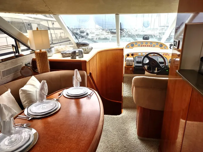 F66 Yacht Photos Pics Luxurious interior of a 1997 Fairline 66 yacht with dining area and helm station.
