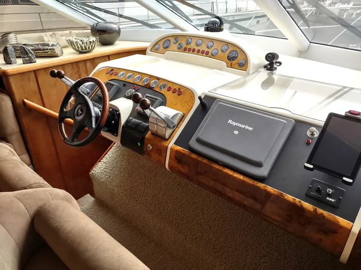 F66 Yacht Photos Pics 1997 Fairline 66 yacht helm station with steering wheel and navigation equipment.