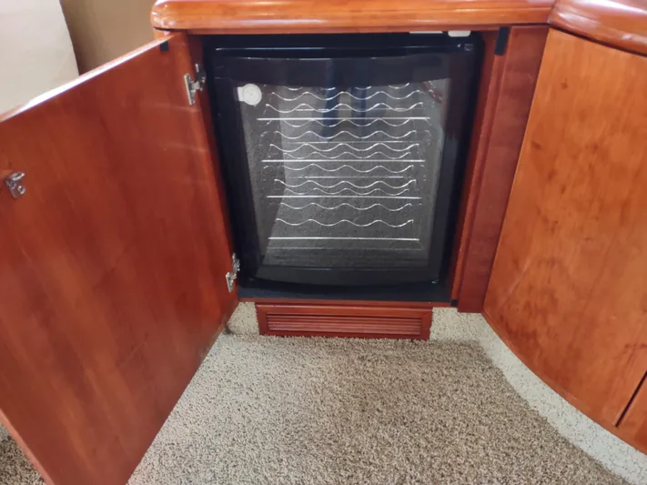 F66 Yacht Photos Pics Built-in wine cooler in 1997 Fairline 66 yacht with wooden cabinetry.