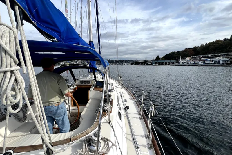  Yacht Photos Pics Sailboat Taswell 43 from 1989 on calm waters, with a person steering.