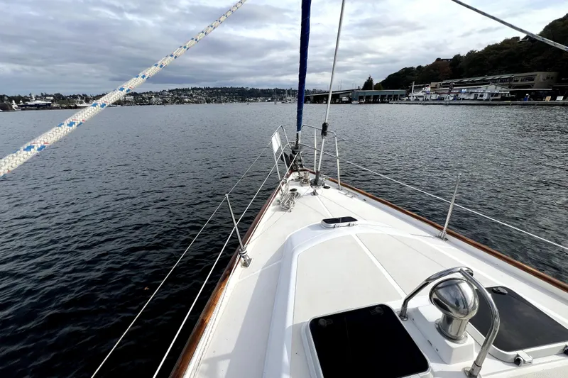  Yacht Photos Pics Sailing on a 1989 Taswell 43 yacht, overlooking calm waters and distant shoreline.