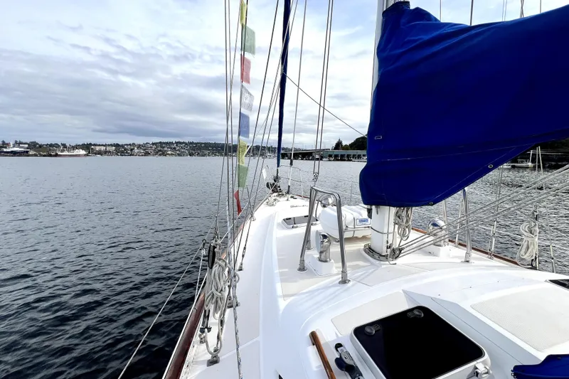  Yacht Photos Pics Sailing on a 1989 Taswell 43 yacht with colorful flags and scenic waterfront views.