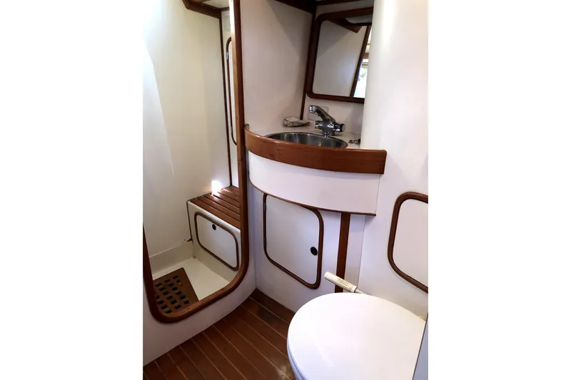  Yacht Photos Pics 1989 Taswell 43 yacht bathroom with wooden accents and compact design.