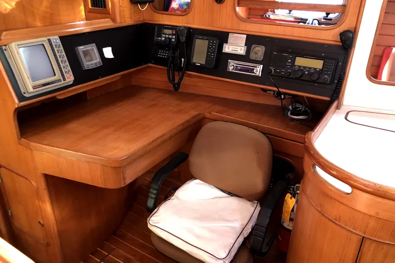  Yacht Photos Pics Navigation station of 1989 Taswell 43 yacht with wooden desk and communication equipment.