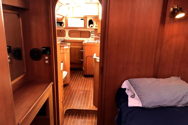  Yacht Photos Pics Interior of 1989 Taswell 43 yacht, featuring wooden cabinetry and cozy sleeping area.