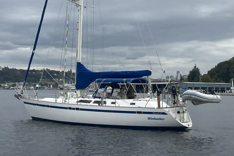  Yacht Photos Pics 1989 Taswell 43 sailboat named "Windwalker" on calm water under cloudy skies.