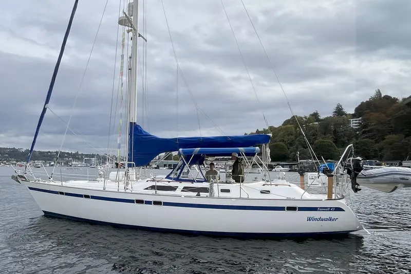 Yacht Photos Pics 1989 Taswell 43 sailboat "Windwalker" on calm water, with blue sail cover and scenic background.