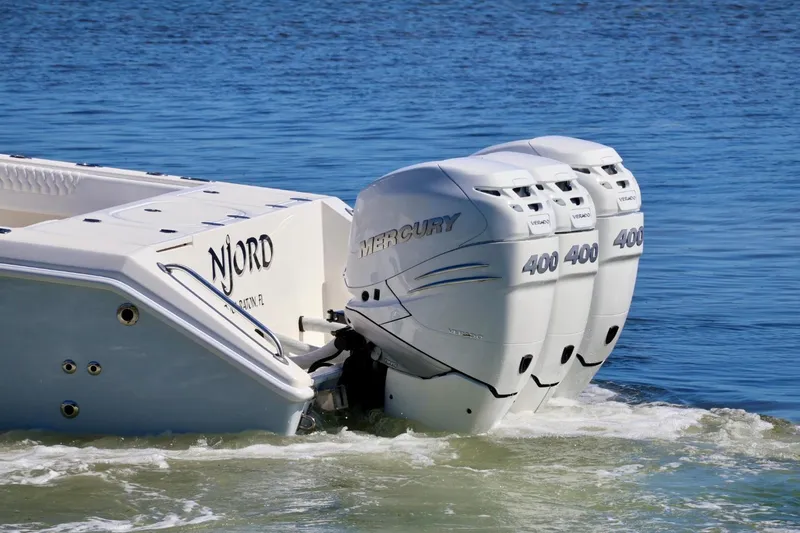  Yacht Photos Pics 2005 Venture 39 Open boat with triple Mercury 400 engines on water.