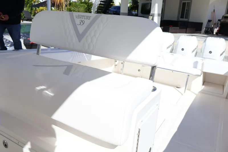  Yacht Photos Pics 2005 Venture 39 Open boat interior with white seating and multiple outboard engines.
