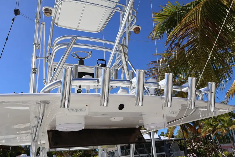  Yacht Photos Pics 2005 Venture 39 Open boat with polished metal structure and palm trees in the background.