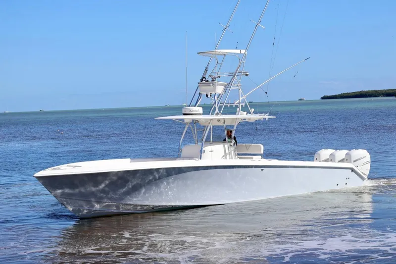  Yacht Photos Pics 2005 Venture 39 Open boat on calm waters, clear sky background.
