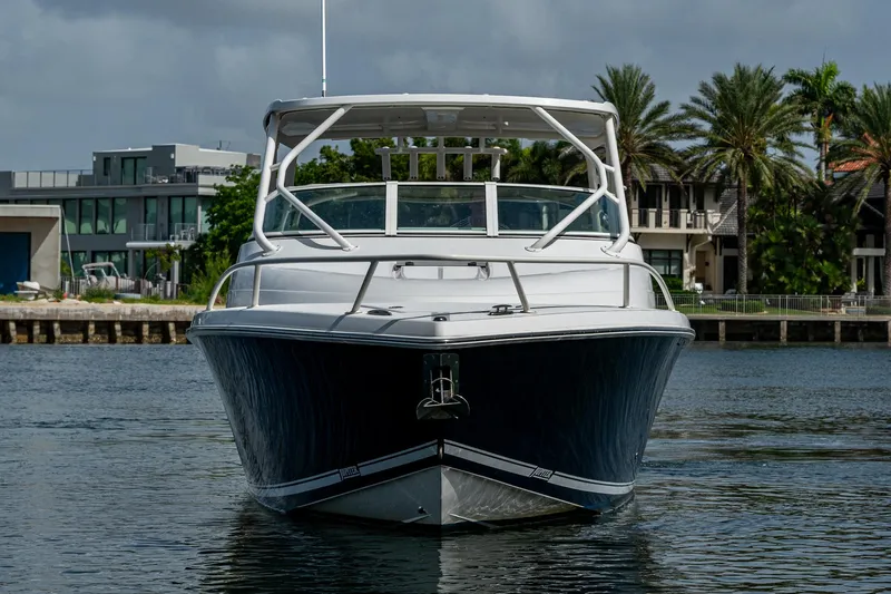 Naider's Yacht Photos Pics 2016 Jupiter 34 LX boat on water, modern waterfront homes in background.