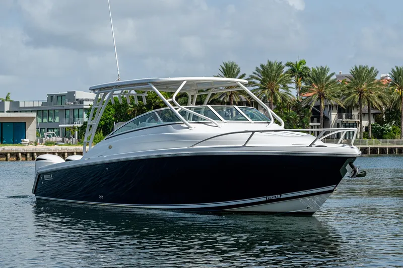 Naider's Yacht Photos Pics 2016 Jupiter 34 LX boat on water, modern waterfront homes in background.