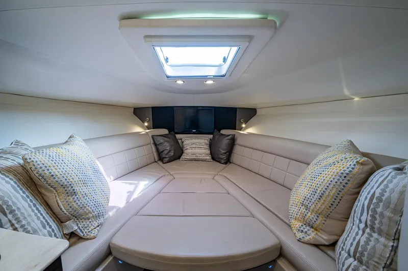 Naider's Yacht Photos Pics Luxurious interior of 2016 Jupiter 34 LX boat with plush seating and skylight.