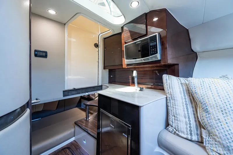 Naider's Yacht Photos Pics Interior of 2016 Jupiter 34 LX boat with modern kitchen and seating area.