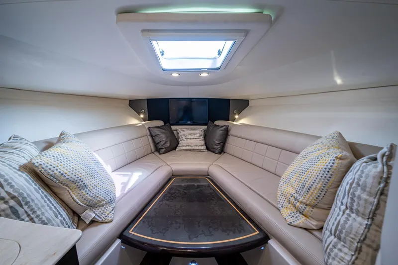 Naider's Yacht Photos Pics Luxurious interior of 2016 Jupiter 34 LX yacht with plush seating and skylight.