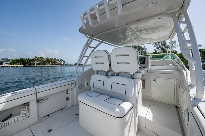 Naider's Yacht Photos Pics 2016 Jupiter 34 LX boat interior with white seating, overlooking a scenic waterfront view.