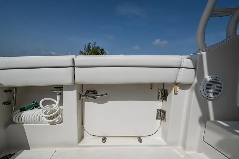 Naider's Yacht Photos Pics 2016 Jupiter 34 LX boat interior with storage compartment and coiled hose.
