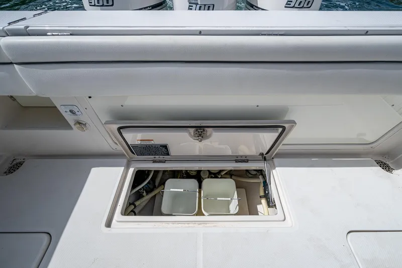 Naider's Yacht Photos Pics 2016 Jupiter 34 LX boat storage compartment with open hatch, revealing interior components.