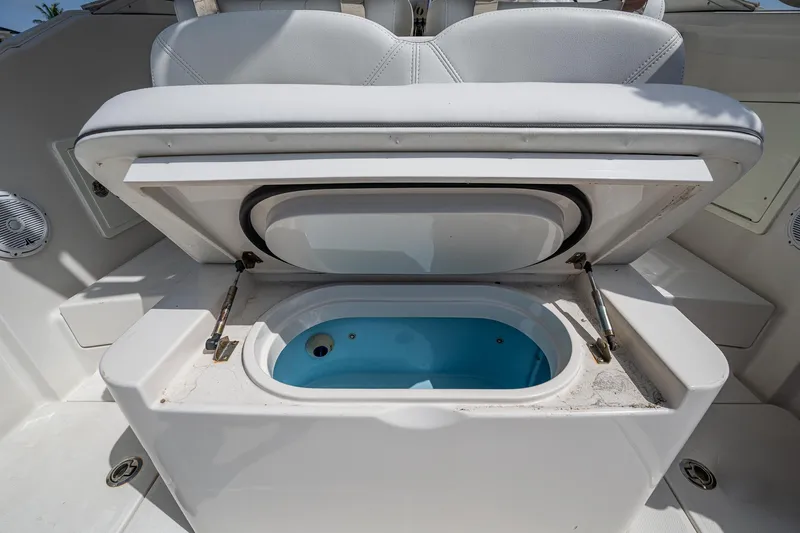 Naider's Yacht Photos Pics Open storage compartment on 2016 Jupiter 34 LX boat, featuring a blue interior.