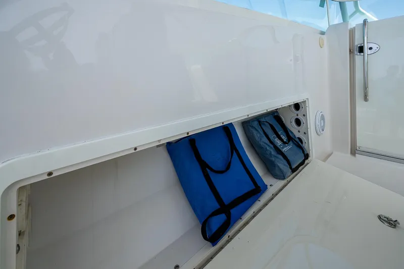 Naider's Yacht Photos Pics Storage compartment on 2016 Jupiter 34 LX boat with blue bags inside.