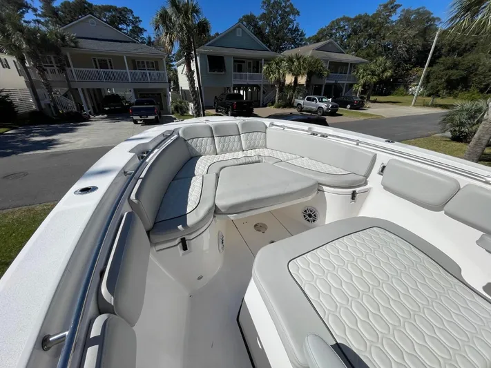  Yacht Photos Pics 2024 Sea Fox 288 Commander boat with spacious seating, parked in a residential area.