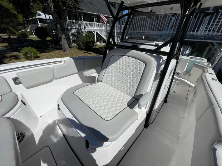  Yacht Photos Pics 2024 Sea Fox 288 Commander boat interior with cushioned seating and sleek design.