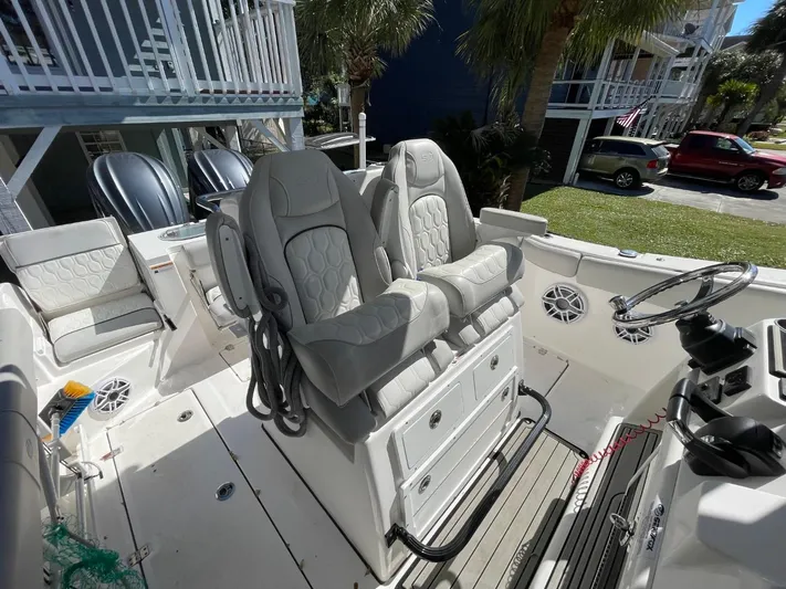  Yacht Photos Pics 2024 Sea Fox 288 Commander boat interior with dual captain's chairs and steering console.