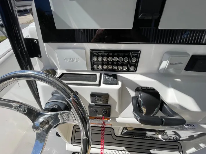  Yacht Photos Pics 2024 Sea Fox 288 Commander dashboard with steering wheel and control panel.