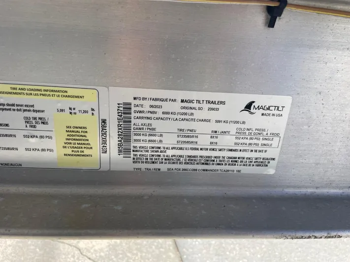  Yacht Photos Pics Label on Magic Tilt trailer, detailing specifications and load information.