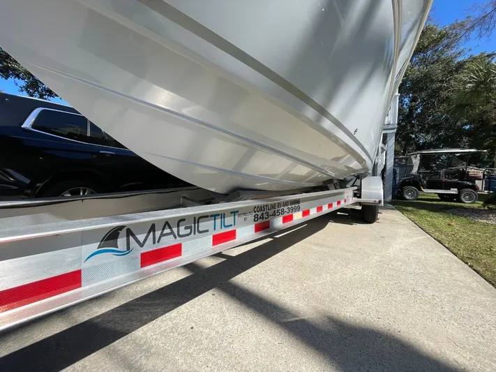  Yacht Photos Pics 2024 Sea Fox 288 Commander boat on Magic Tilt trailer, parked on concrete driveway.