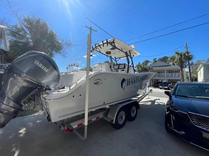  Yacht Photos Pics 2024 Sea Fox 288 Commander boat on trailer, parked outdoors under clear blue sky.