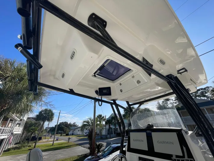  Yacht Photos Pics 2024 Sea Fox 288 Commander boat with T-top and Garmin electronics, parked near palm trees.