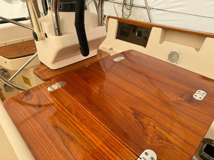 Essence Yacht Photos Pics Polished wooden cockpit table on 1998 Island Packet 40 sailboat.