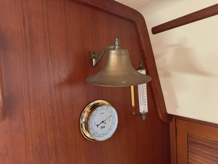 Essence Yacht Photos Pics Brass lamp and barometer on Island Packet 40 yacht's wooden interior, 1998 model.