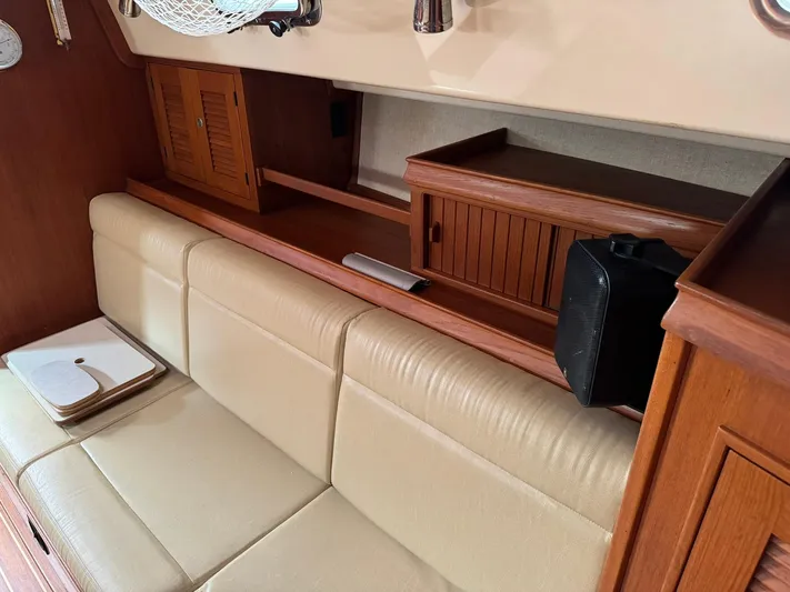 Essence Yacht Photos Pics Interior of 1998 Island Packet 40 sailboat with beige seating and wooden cabinetry.