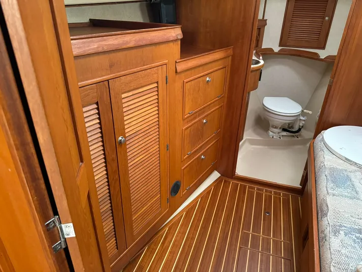 Essence Yacht Photos Pics Interior of 1998 Island Packet 40 sailboat with wooden cabinetry and marine toilet.