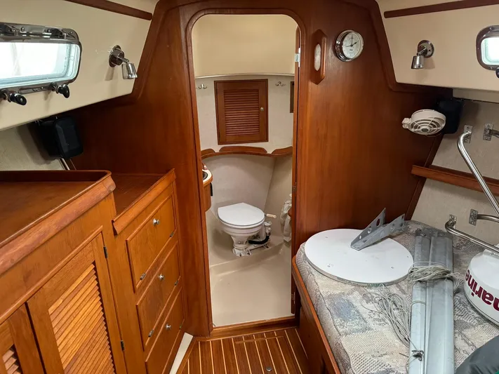 Essence Yacht Photos Pics Interior of 1998 Island Packet 40 sailboat with wooden cabinetry and compact bathroom.