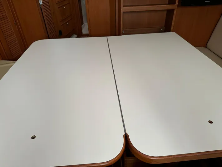 Essence Yacht Photos Pics Interior table of 1998 Island Packet 40 sailboat, featuring a foldable design.
