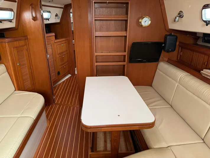 Essence Yacht Photos Pics Interior of 1998 Island Packet 40 sailboat with wood finish and beige seating.